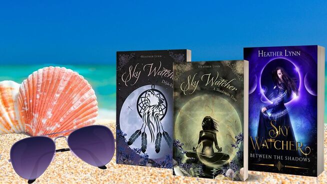 3 books of the sky watcher series standing in the sand on a beach beside some shells and sunglasses