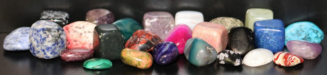 Image of many stones/gems in variety of shapes and colours.