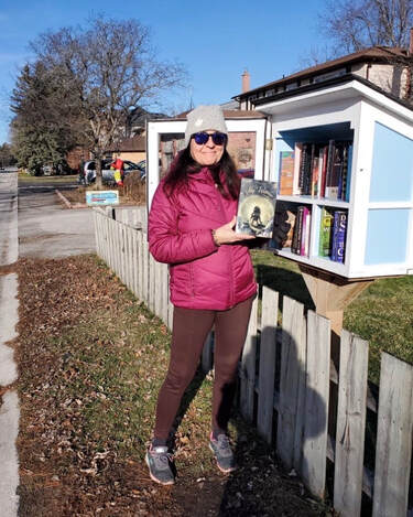 me adding book to little library in the neighbourhoodture